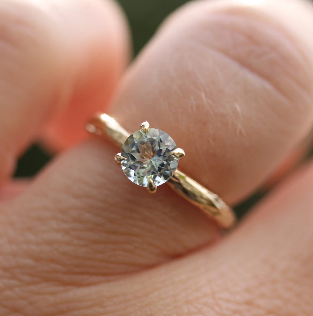 Pale blue gemstone ring on the finger