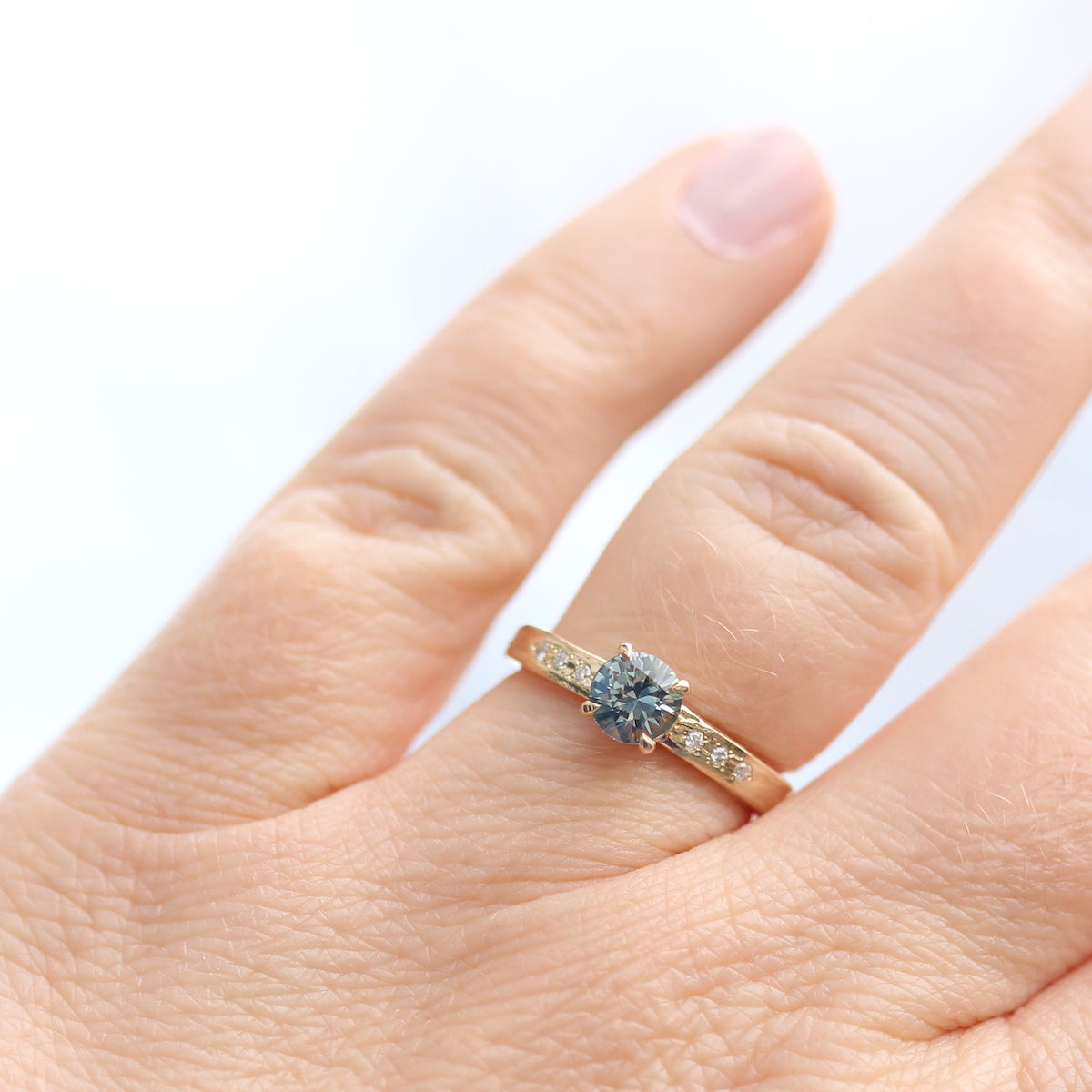 Yellow gold solitaire ring with blue sapphire