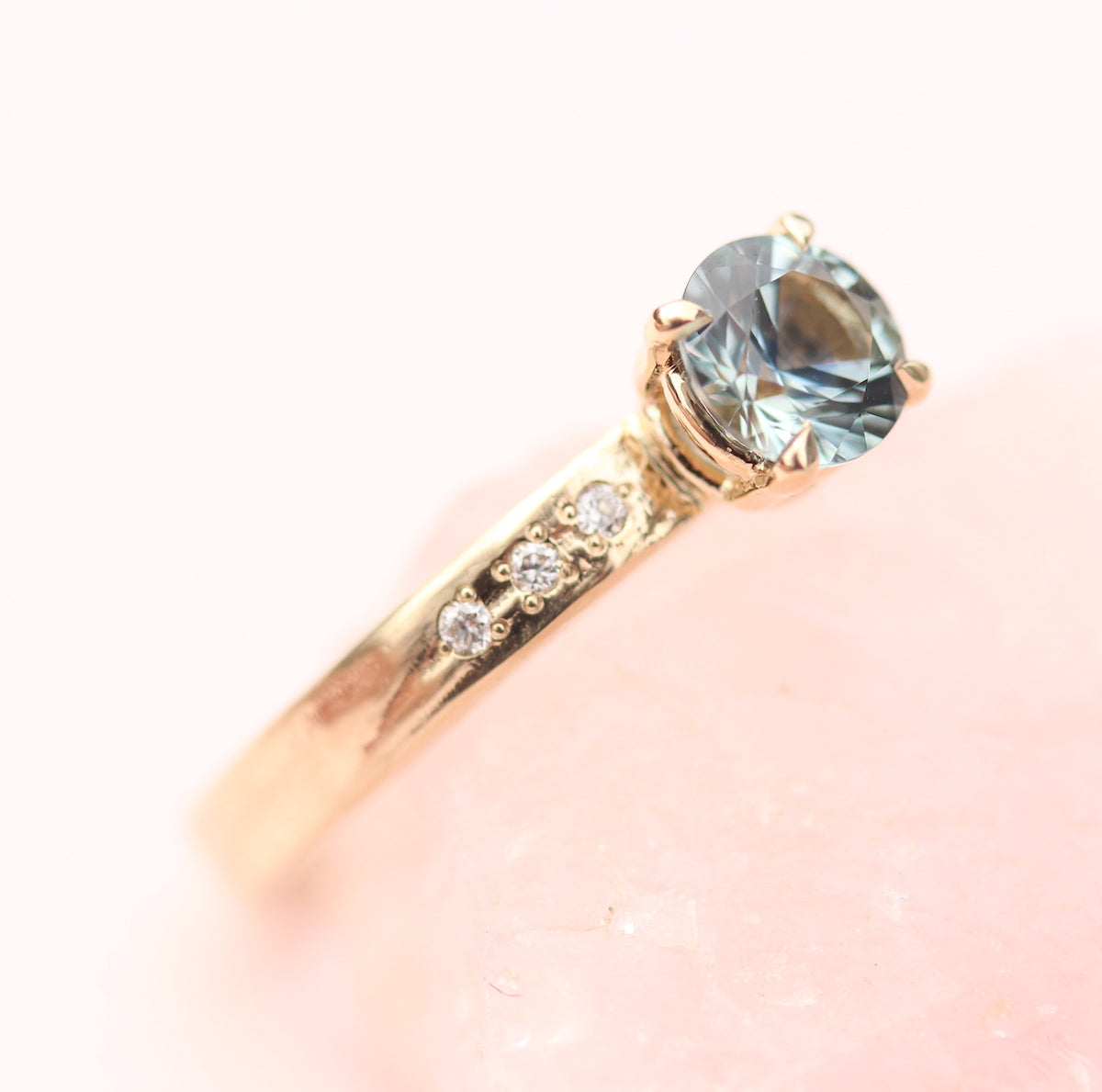 Teal Sapphire ring with diamonds on the band by Toronto jewelry designer