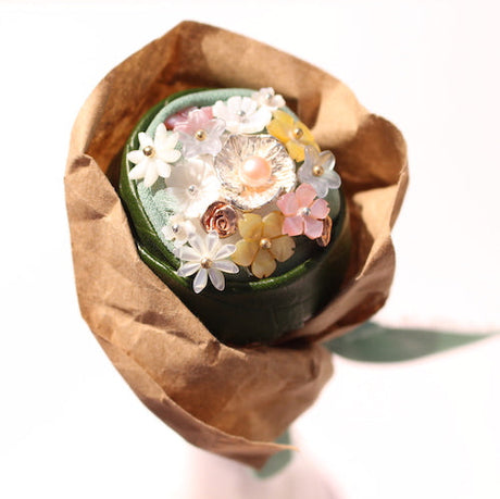 Rose quartz stud earrings with rose gold settings sitting on a piece of marble