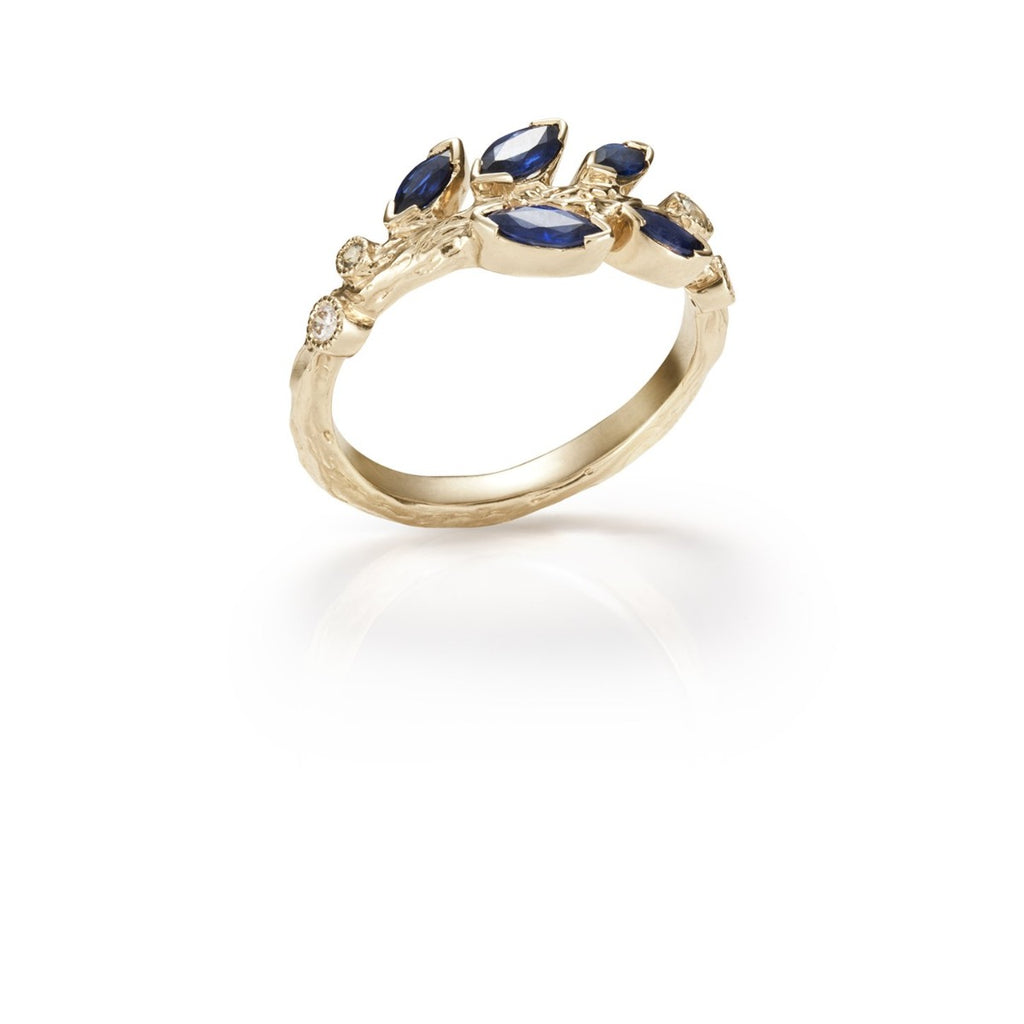 Yellow gold ring with blue sapphire leaf design