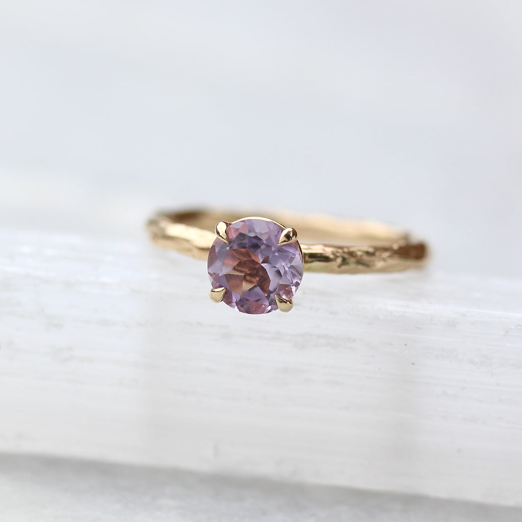 Amethyst ring on white background 