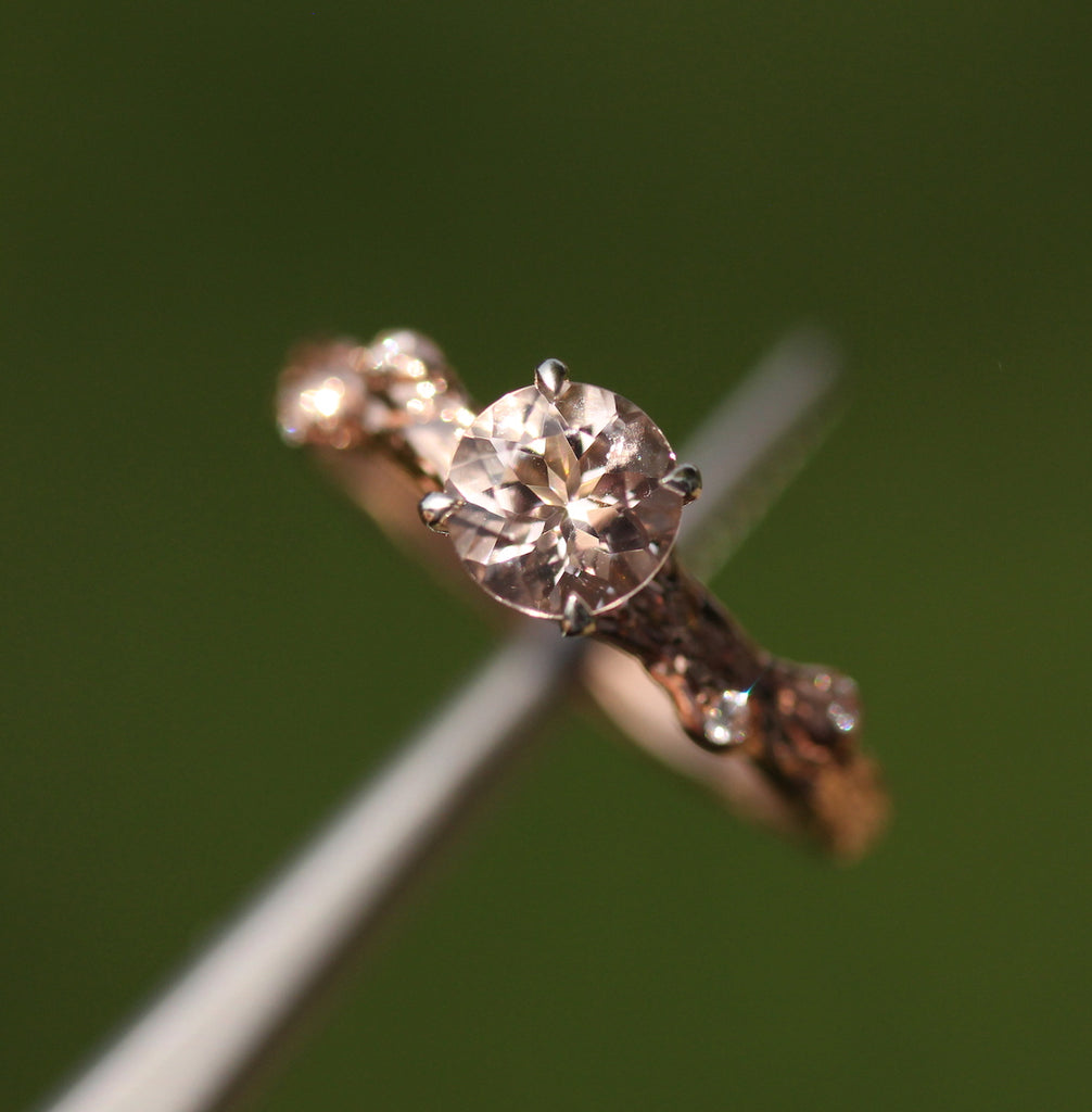 Rose gold and morganite ring on a green background