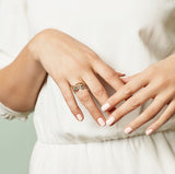 Green sapphire ring set on hand