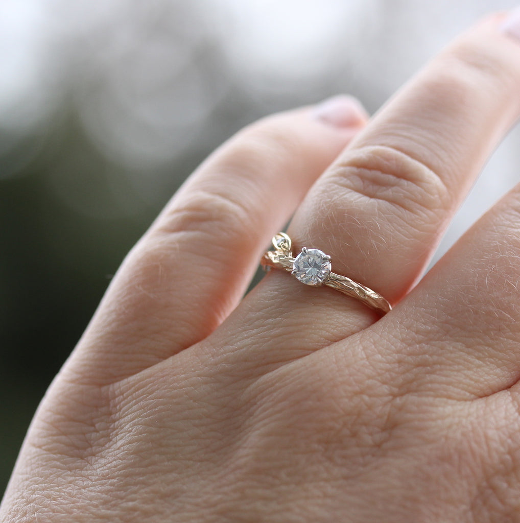 branch and leaf engagement ring on the finger