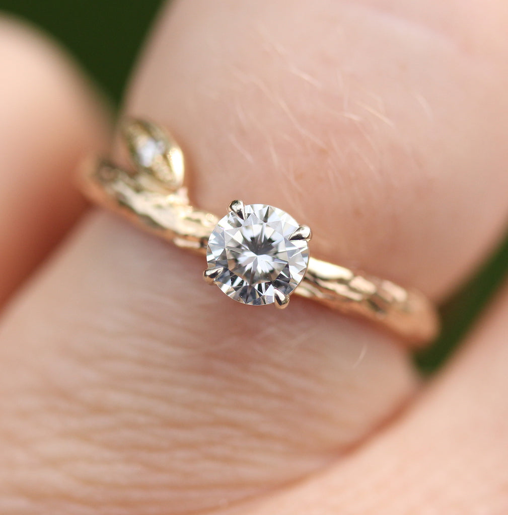 diamond and branch engagement ring on the finger