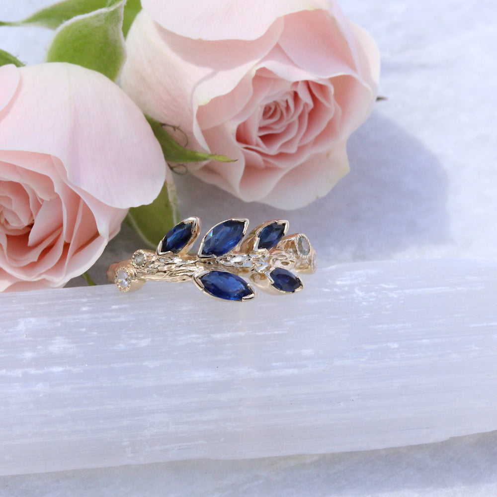 blue sapphire Marquise Leaf Ring  on marble
