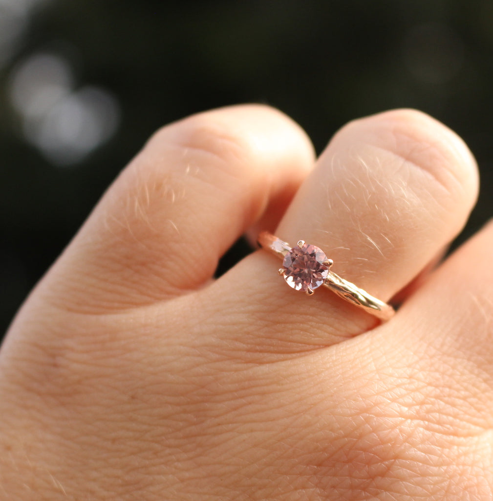 rose gold and pink garnet ring on the finger